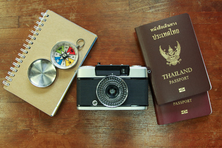 Outfit of traveler, student, teenager, young woman or guy. Overhead of essentials for modern young person. Different objects on wooden background.の写真素材