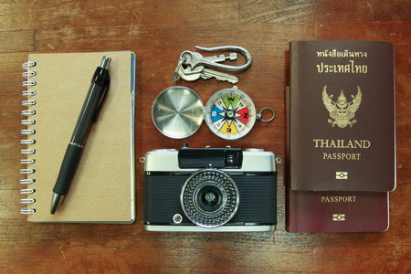 Outfit of traveler, student, teenager, young woman or guy. Overhead of essentials for modern young person. Different objects on wooden background.の写真素材