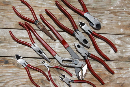 pliers on wooden table.