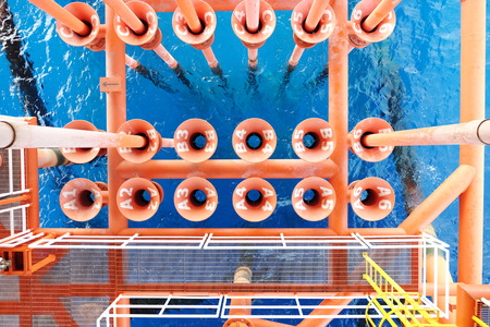 Oil and Gas Producing Slots at Offshore Platform, Oil and Gas Industry. Well head slot on the platform or rig. Production and Explorer industry.の写真素材