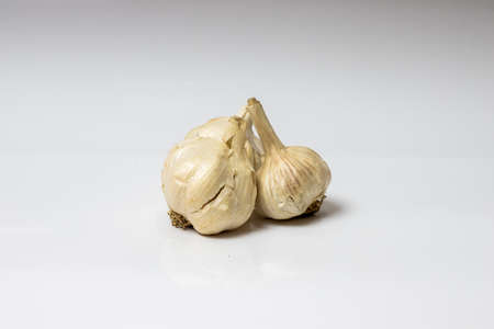 Bunch of garlic isolated on white glossy backgroundの写真素材