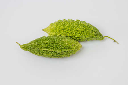 Two bitter melon isolated on white backgroundの写真素材