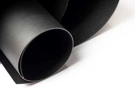 Abstract close up rolled textured black art papers isolated on white background