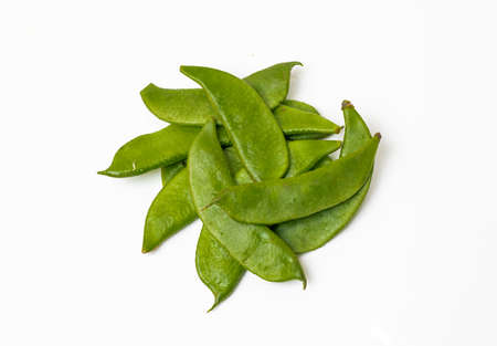 A pile of green organic beans isolated on white background