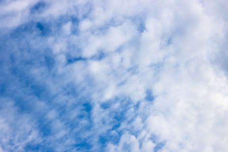 Blue sky background with white flying cloud