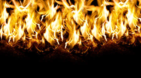 Burning papers on the ground fire flame close up shot isolated on black background