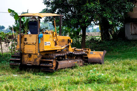 Keraniganj, Dhaka, Bangladesh - 15 May 2021: An unused old rusty Bulldozer kept on grassland for a long timeのeditorial素材