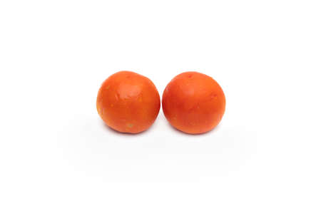 Two fresh organic tomatoes on isolated white background with water dropsの写真素材