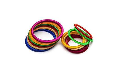 Two piles of colorful bobbin bangles on isolated white background