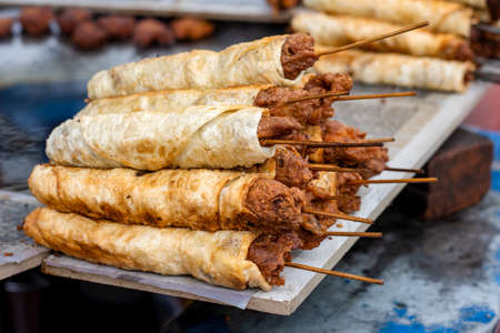 Delicious fried street food seekh kabab on a wooden board close upの写真素材