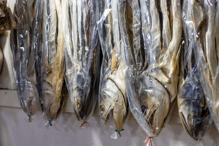 A row of hanging dried sea fish on a shop close up with selective focus