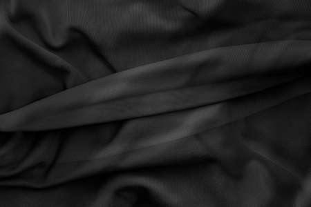 Monochromatic view of folded silk fabric  with rough texture for backgroundの写真素材