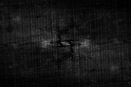 Cracked dark timber surface with grunge texture for backgroundの写真素材