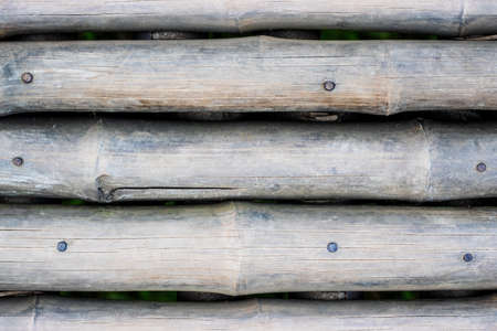 Close up view of a rustic old abandoned bamboo fence