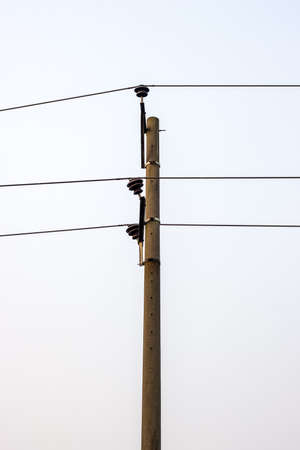 Vertical shot of electricity transmission pole in the urban areaの写真素材