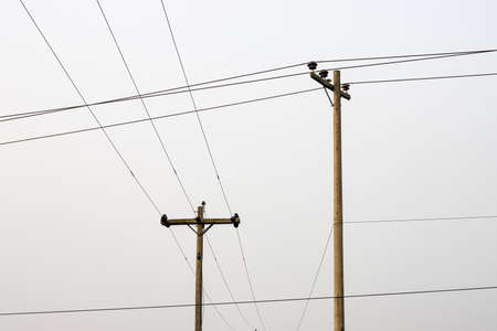 Two high voltage electricity transmission poles together in the urban area