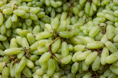 A pile of organic fresh tasty green grape close up shot with selective focus