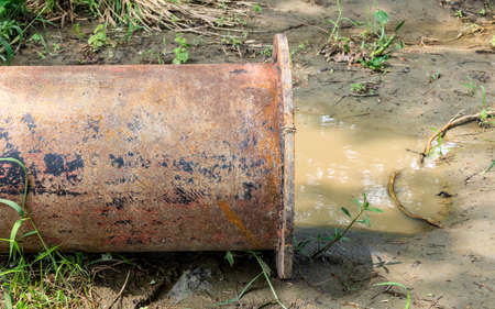 Close up shot of a dredging pipe on a muddy landの写真素材