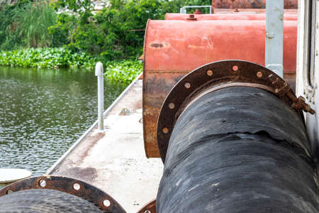 Stored old water cylinder and dredging pipes on a ship close up with copy spaceの写真素材