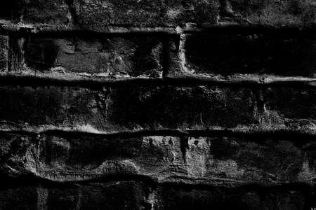 Abstract dark brick structural rough concrete wall surface for texture backgroundの写真素材