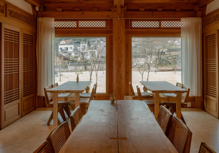 Interior of a restaurant with wooden tables, chairs and window.の写真素材