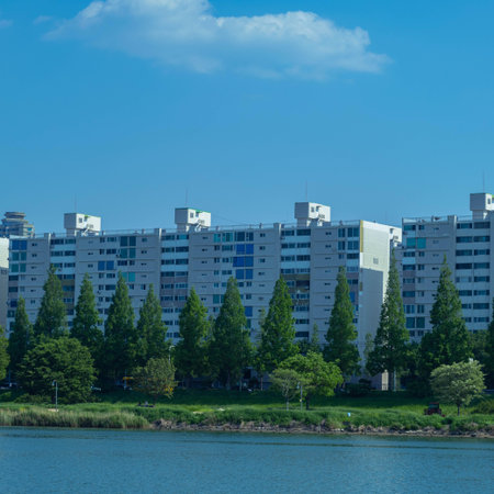 Modern apartment buildings on the bank of the river in a sunny day