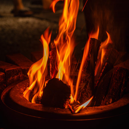 Burning wood in a brazier at night, close upの写真素材