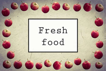 FRESH FOOD text presentation front page on vintage paper background and apple ornament.