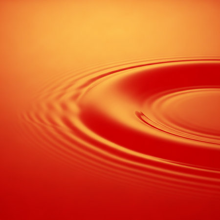 Circular water ripples on orange liquid surface. Abstract design for backgrounds or wallpapers. Great for graphic design projects and for demonstrating concepts related to waves, circlesの素材
