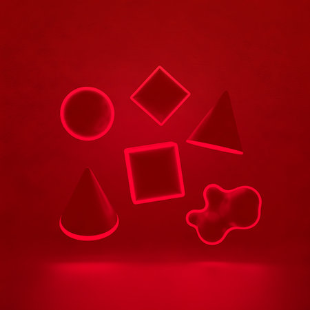 Collection of geometric shapes illuminated in red light creates abstract arrangement. For modern design and visual composition on red surface. Contemporary element.の素材