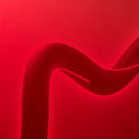 Abstract composition features curved tube illuminated by red light creating graphic design element. Artistic background with modern aesthetic and dynamic structure element.の素材