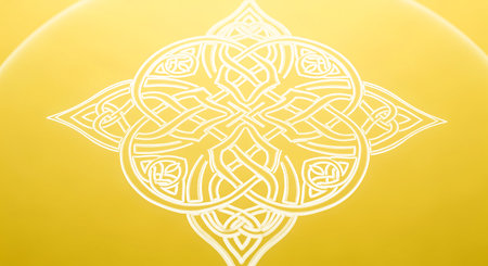 Yellow celtic knot emblem in abstract design. The symbol is illuminated against light yellow backdrop creating mesmerizing and artistic pattern.の素材