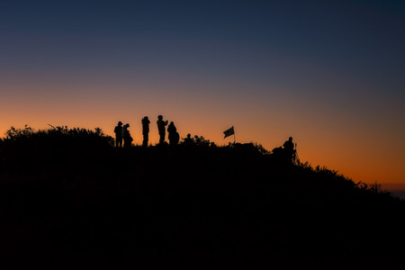 Silhouette A group of people stands on a mountains at the sunrise  On the top Doi Luang Chiang Dao Thailandの写真素材