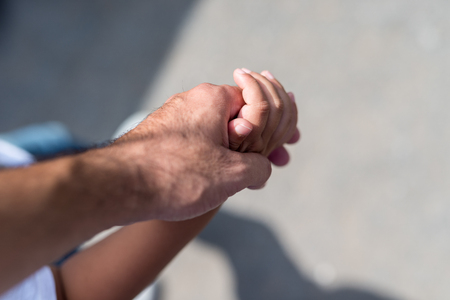 Father and son holding hand in hand