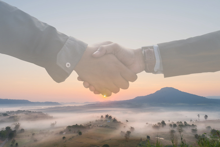 Double exposure of businessman at landscape background handshake agreement Business tourism concepts.の写真素材