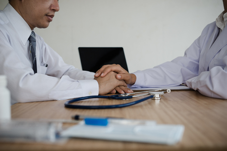 Doctor's hand holding hands patient encouragement. healthcare and medical conceptの写真素材