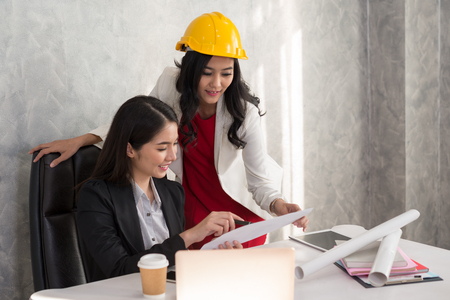 Business girl and engineer with Asian people are talking about a new project within the business office.の写真素材