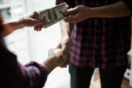 People working man and woman in a plaid shirt of handshake of business partners. Profit Business...