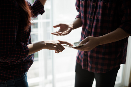 People working man and woman in a plaid shirt . Argue about the business benefitsの写真素材