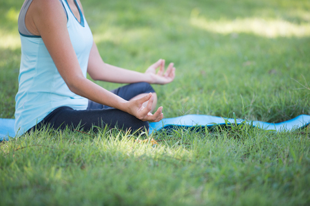 Elderly woman with yoga exercise outdoors at the park. Health and Fitness conceptの写真素材