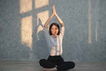 Asian business girl  practicing yoga in the office. concept relaxing on workplaceの写真素材