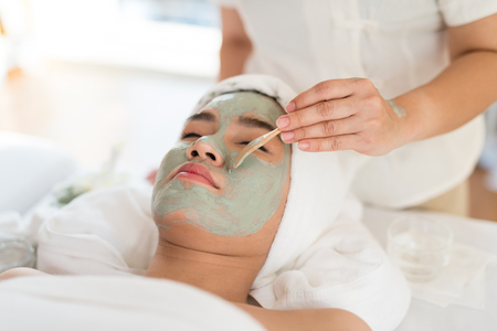 A female therapist doing Facial Spa/Treatment Add moisture to the skin with Asian woman lying on a bed in spa salon.の写真素材