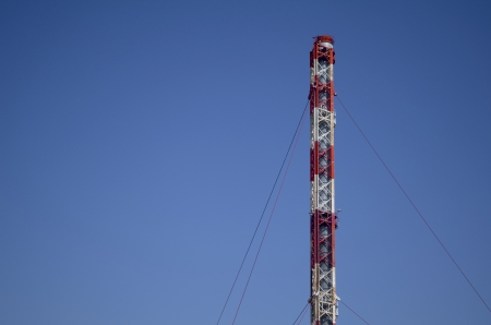Red and White Industrial Chimney Fixed with Cablesの写真素材