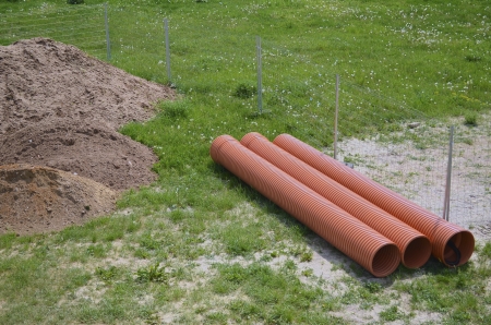 Construction Area with Plastic Pipes on a Meadowの写真素材