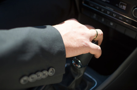 Driving Groom's Hand on Car Shift Knob Closeup