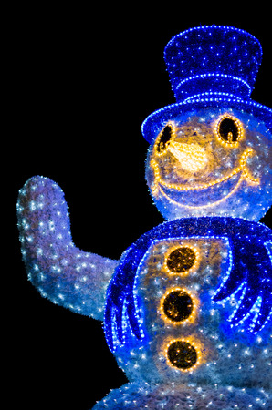 Blue Snowman Decoration Lights Closeup Vertical Isolated on Black Backgroundの写真素材