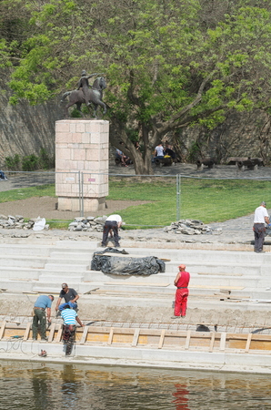 Half Dozen Working Men Renovating the Raba River Bankの写真素材
