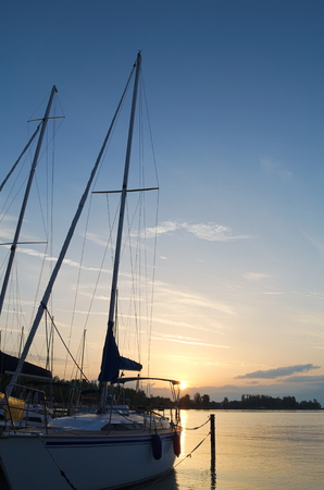 Sailboat on Lake Balaton at Dawn with Blue Skyの写真素材