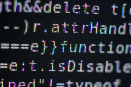 White Program Source Code Segment on Black Screen Macro Closeup