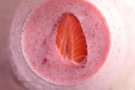 Halved Strawberry in Milk Shake Closeup Top Viewの写真素材